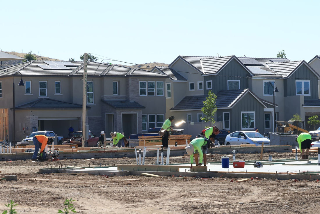 Construction crew laying foundations at a residential development