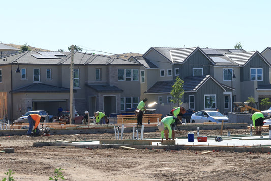 Construction crew laying foundations at a residential development