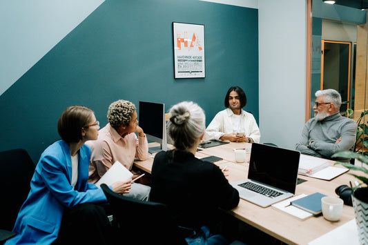 Operations team meeting around a conference table in a modern office