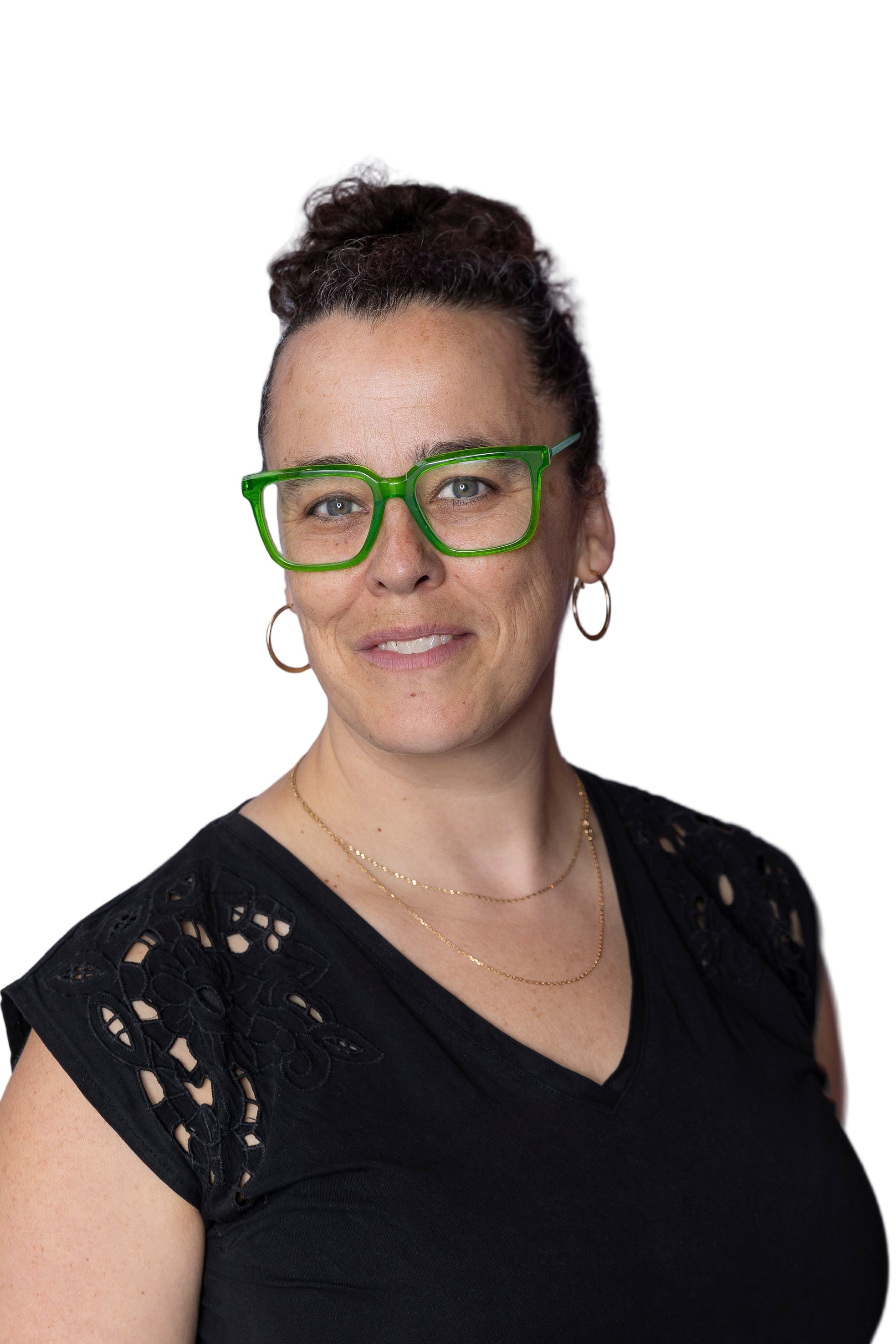 Woman wearing green glasses and a black top against a light purple background