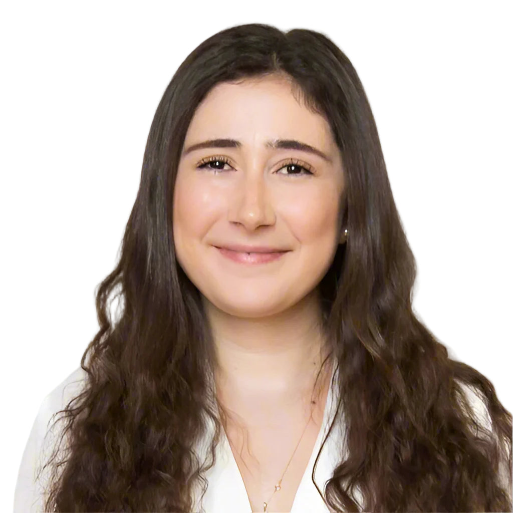 Woman with long dark hair wearing a white shirt on a plain background